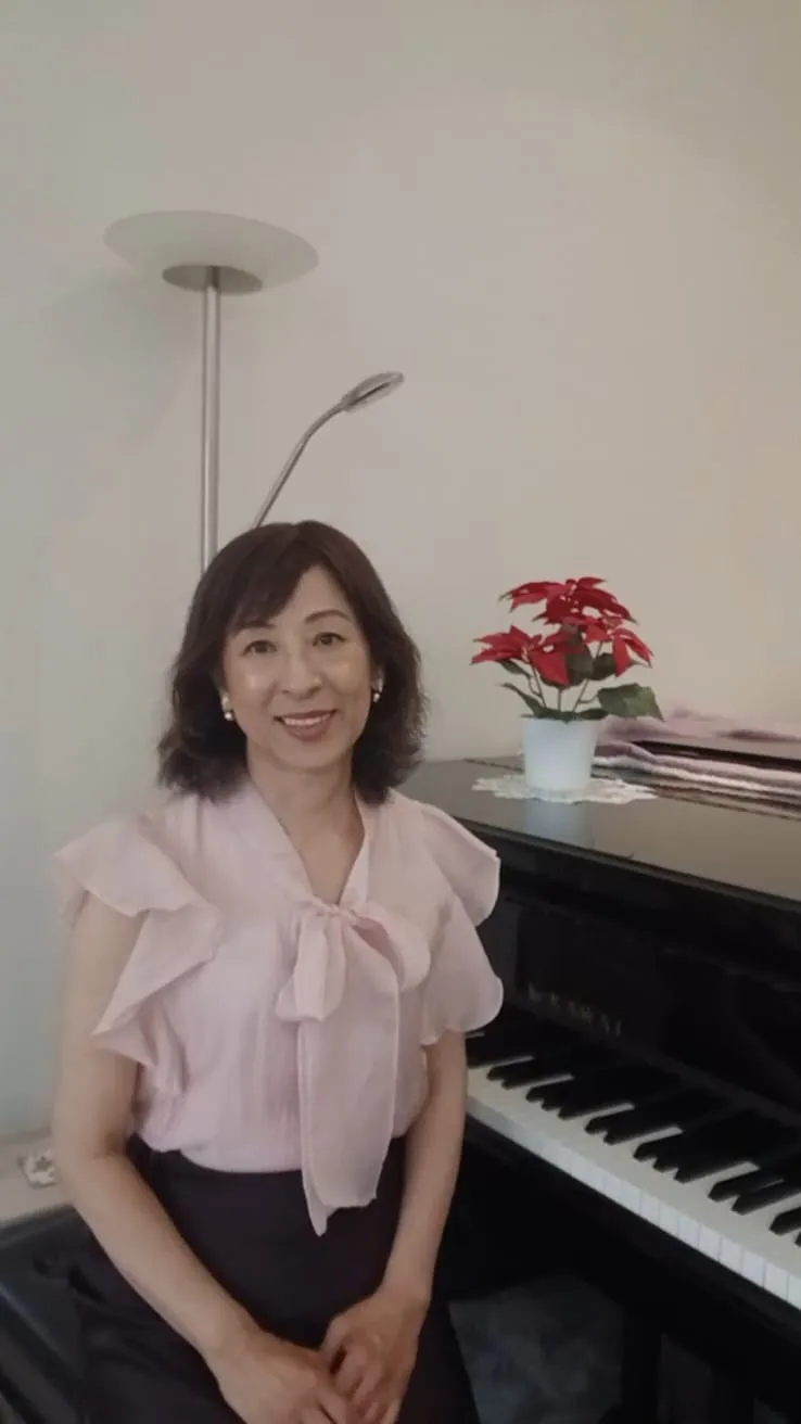 Lien-Ying Lin seated beside her grand piano