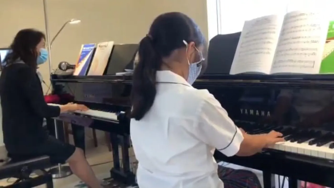 Students practising at the upright pianos