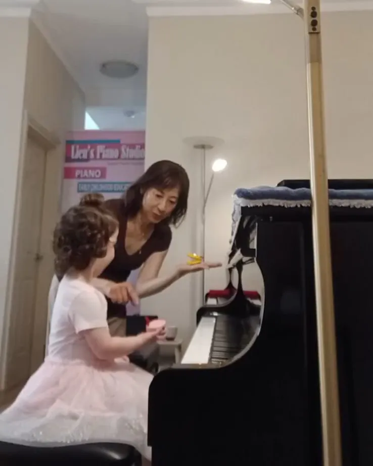A young student learning at the piano